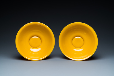 A pair of Chinese yellow Beijing glass bowls with figures in mountainous landscapes, 19/20th C.