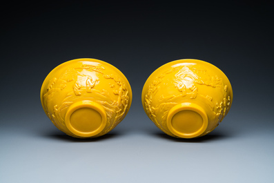 A pair of Chinese yellow Beijing glass bowls with figures in mountainous landscapes, 19/20th C.