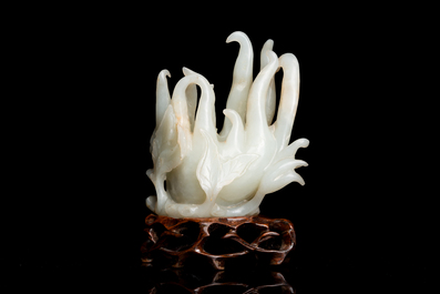 A fine Chinese white jade carving of a Buddha's hand on wooden stand, Qing