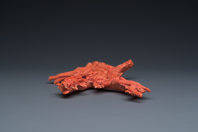 A Chinese red coral figure of a standing Guanyin with a dragon, 19/20th C.