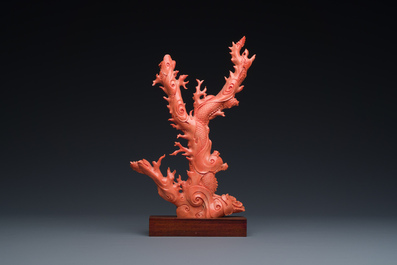 A Chinese red coral figure of a standing Guanyin with a dragon, 19/20th C.