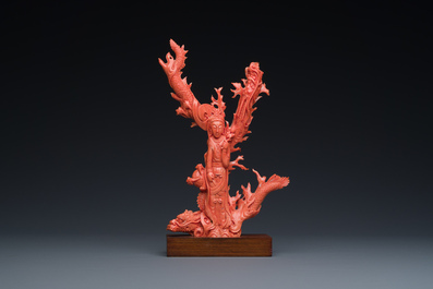 A Chinese red coral figure of a standing Guanyin with a dragon, 19/20th C.