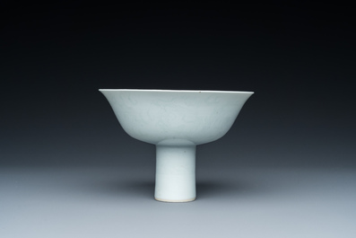 A Chinese monochrome white-glazed stem cup with anhua dragon design, Qianlong mark, 18/19th C.