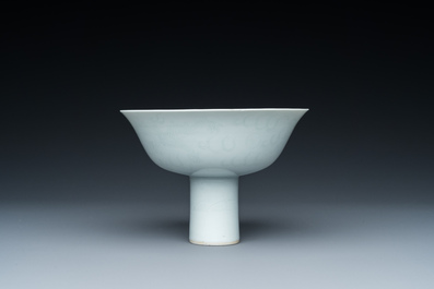 A Chinese monochrome white-glazed stem cup with anhua dragon design, Qianlong mark, 18/19th C.