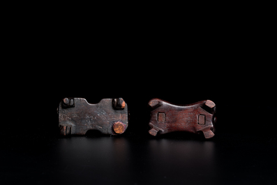 A Chinese celadon and russet jade 'bi' disc and a spinach green flower-shaped pendant on wooden stands, Ming and Qing