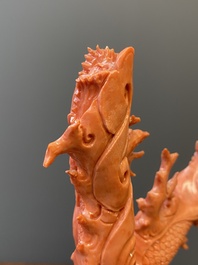 A Chinese red coral figure of a standing Guanyin with a dragon, 19/20th C.