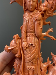 A Chinese red coral figure of a standing Guanyin with a dragon, 19/20th C.