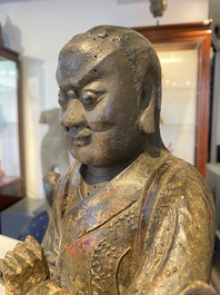 A Chinese lacquered and polychromed wood sculpture of a Buddhist guardian, Ming