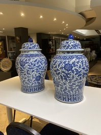 A pair of large Chinese blue and white 'lotus scroll' vases and covers, 19th C.