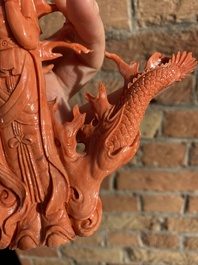 A Chinese red coral figure of a standing Guanyin with a dragon, 19/20th C.