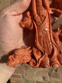 A Chinese red coral figure of a standing Guanyin with a dragon, 19/20th C.