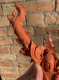 A Chinese red coral figure of a standing Guanyin with a dragon, 19/20th C.