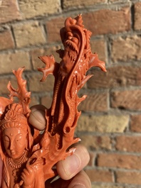 A Chinese red coral figure of a standing Guanyin with a dragon, 19/20th C.