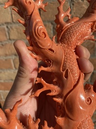 A Chinese red coral figure of a standing Guanyin with a dragon, 19/20th C.