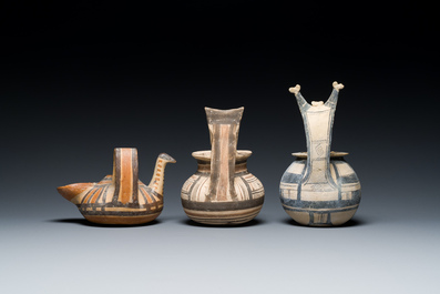 Two geometrical decorated Daunian pottery vessels and an olive press, Southern Italy, 6th/3rd C. b.C.