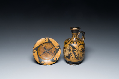 An Etruskian 'aryballos' portrait ewer and a 'patera' dish with black geometrical design, 4th C. b.C.