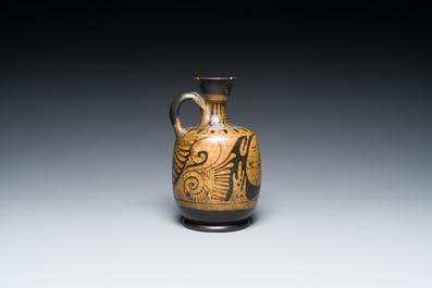 An Etruskian 'aryballos' portrait ewer and a 'patera' dish with black geometrical design, 4th C. b.C.