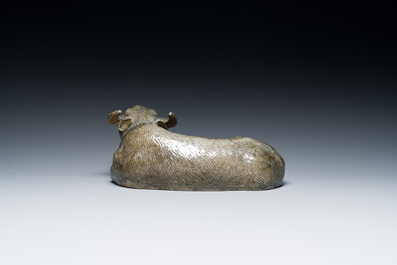 A Chinese monochrome brown-grey-glazed sculpture of a reclining water buffalo on wooden stand, 19th C.