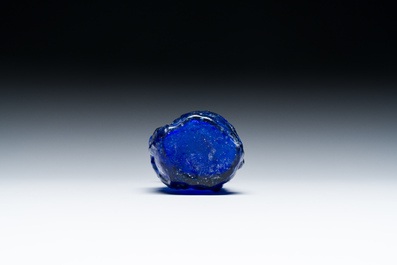 A Roman &lsquo;Sidonian&rsquo; dark blue 'erotic subject' molded glass bottle, Eastern Mediterranean, ca. 1st C.