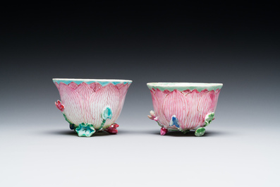 A pair of Chinese relief-decorated famille rose 'lotus' cups and saucers with a scholar and his servant, Yongzheng