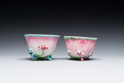 A pair of Chinese relief-decorated famille rose 'lotus' cups and saucers with a scholar and his servant, Yongzheng