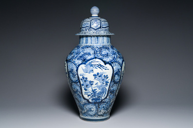 A pair of Japanese Imari vases with flower-topped covers and a large blue and white Arita vase, Edo, 17/18th C.