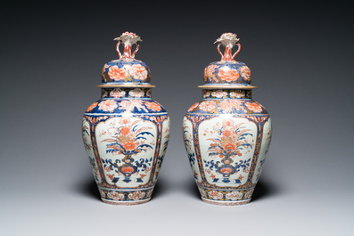 A pair of Japanese Imari vases with flower-topped covers and a large blue and white Arita vase, Edo, 17/18th C.