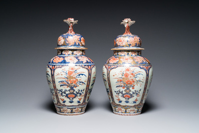 A pair of Japanese Imari vases with flower-topped covers and a large blue and white Arita vase, Edo, 17/18th C.