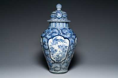 A pair of Japanese Imari vases with flower-topped covers and a large blue and white Arita vase, Edo, 17/18th C.