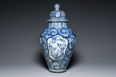 A pair of Japanese Imari vases with flower-topped covers and a large blue and white Arita vase, Edo, 17/18th C.