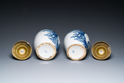 A pair of Dutch Delft blue and white tobacco jars with brass covers, 18th C.