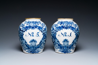 A pair of Dutch Delft blue and white tobacco jars with brass covers, 18th C.