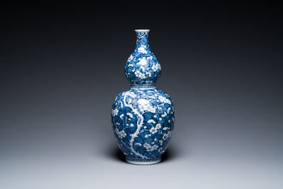 A Chinese blue and white double gourd 'prunus on cracked ice' vase, 18th C.