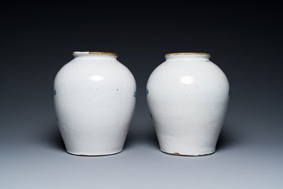 A pair of Dutch Delft blue and white tobacco jars with brass covers, 18th C.