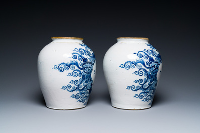 A pair of Dutch Delft blue and white tobacco jars with brass covers, 18th C.