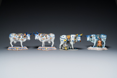 A pair of polychrome Dutch Delft cows and two 'milking' groups, 18/19th C.