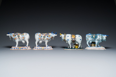 A pair of polychrome Dutch Delft cows and two 'milking' groups, 18/19th C.