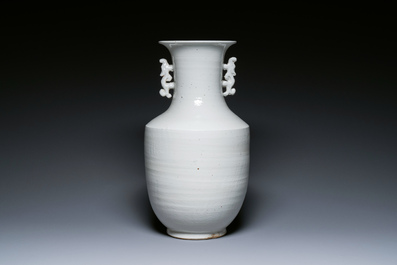 A Chinese white-glazed vase on wooden stand, 19th C.