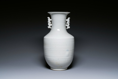 A Chinese white-glazed vase on wooden stand, 19th C.