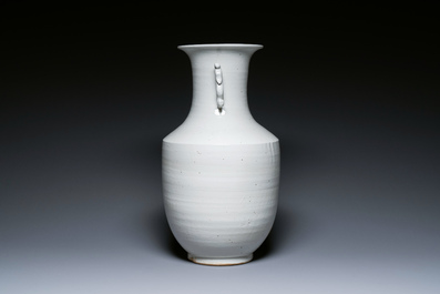 A Chinese white-glazed vase on wooden stand, 19th C.