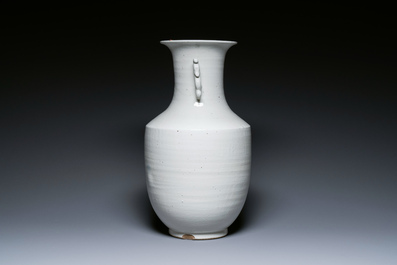 A Chinese white-glazed vase on wooden stand, 19th C.