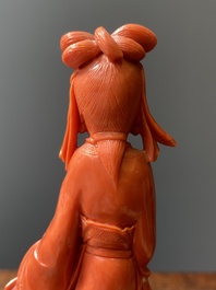 A Chinese red coral figure of a lady with a fan, 19/20th C.