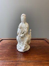 A Chinese Dehua blanc de Chine figure of Guanyin with a boy, Kangxi/Qianlong