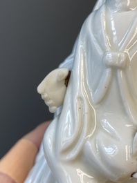 A Chinese Dehua blanc de Chine figure of Guanyin with a boy, Kangxi/Qianlong