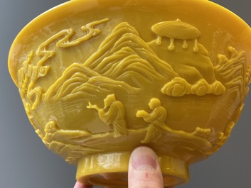 A pair of Chinese yellow Beijing glass bowls with figures in mountainous landscapes, 19/20th C.