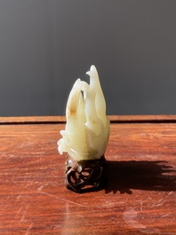 A fine Chinese white jade carving of a Buddha's hand on wooden stand, Qing