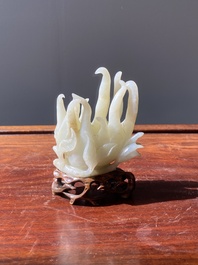 A fine Chinese white jade carving of a Buddha's hand on wooden stand, Qing