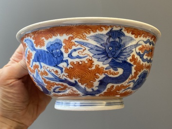 A Chinese blue, white and iron-red 'dragon' bowl and a famille rose 'immortals' bowl, Jiaqing and Wanli mark, 19th C.