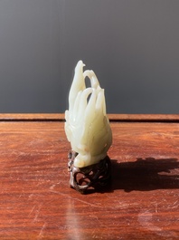 A fine Chinese white jade carving of a Buddha's hand on wooden stand, Qing