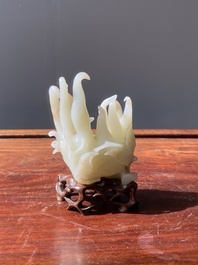 A fine Chinese white jade carving of a Buddha's hand on wooden stand, Qing